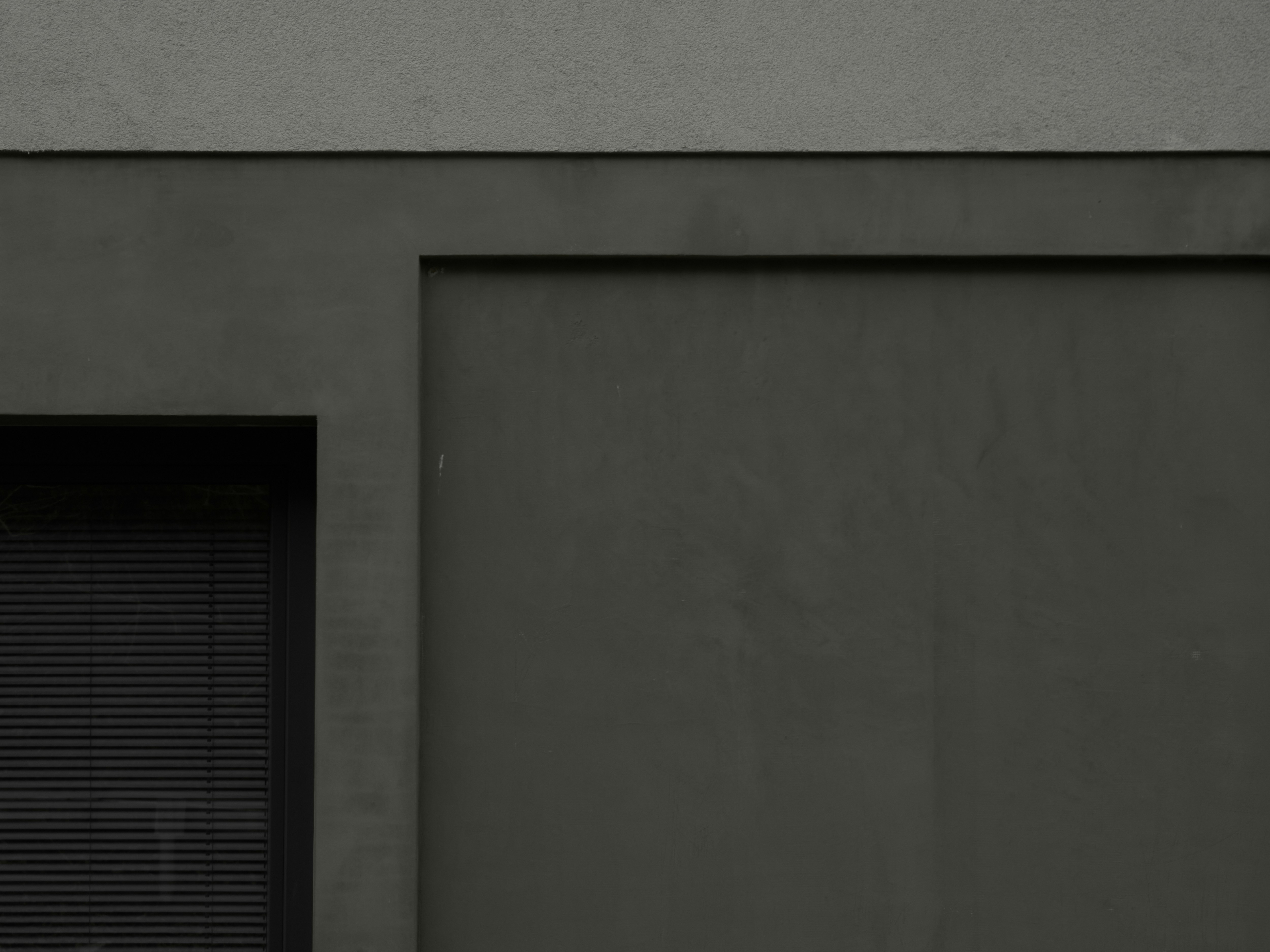 a black and white photo of a building with a closed door